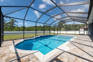 A screen covered new build pool in a Secure Built home.