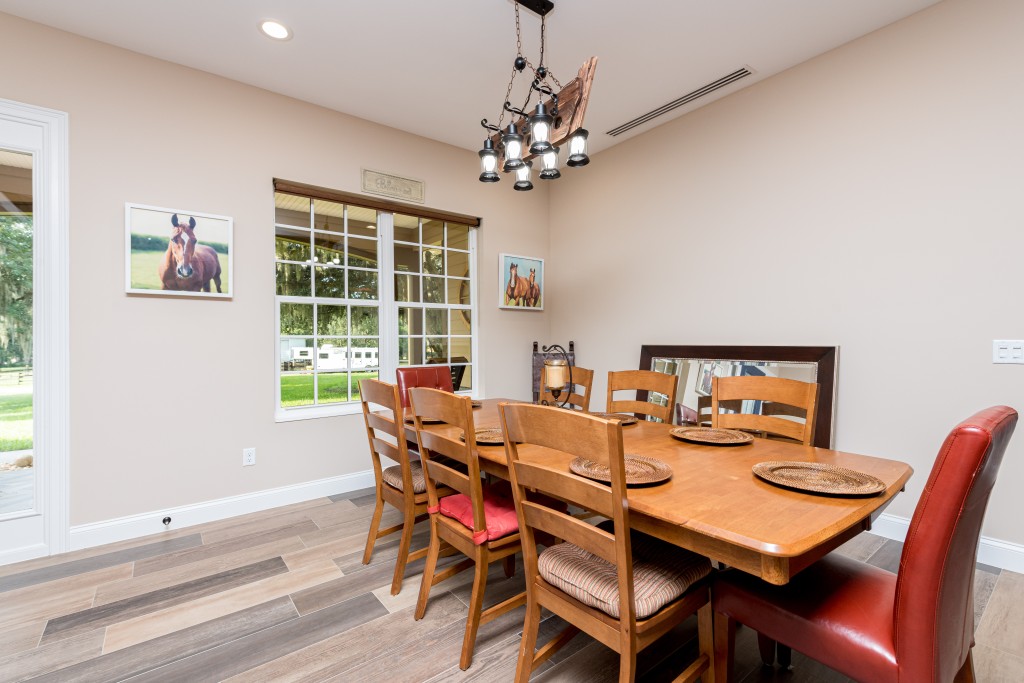 Dining area featuring a rustic wooden chandelier. 