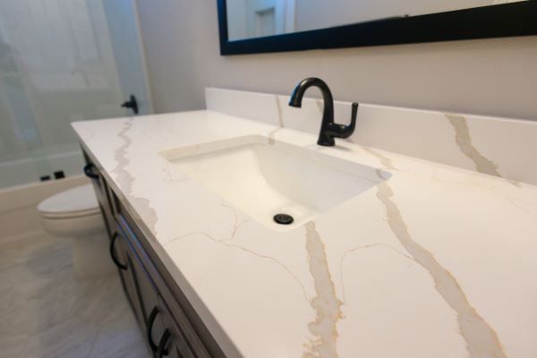 Bathroom with soft and warm-toned countertops. 