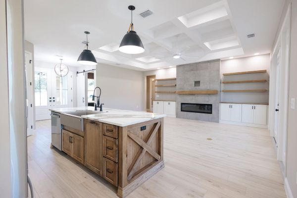 Wood island and custom wood built ins in a kitchen and living room. 